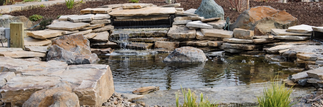 Rock pond and stone waterfall landscaping